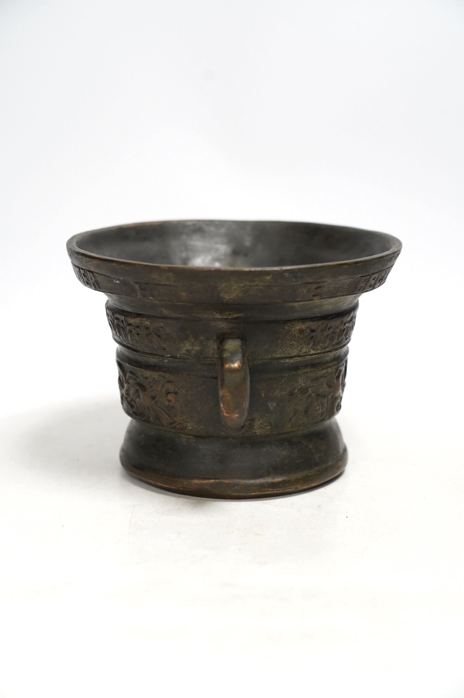 After Heinrich Ter Horst, a heavy cast bronze twin handled mortar, 13cm high. Condition - fair